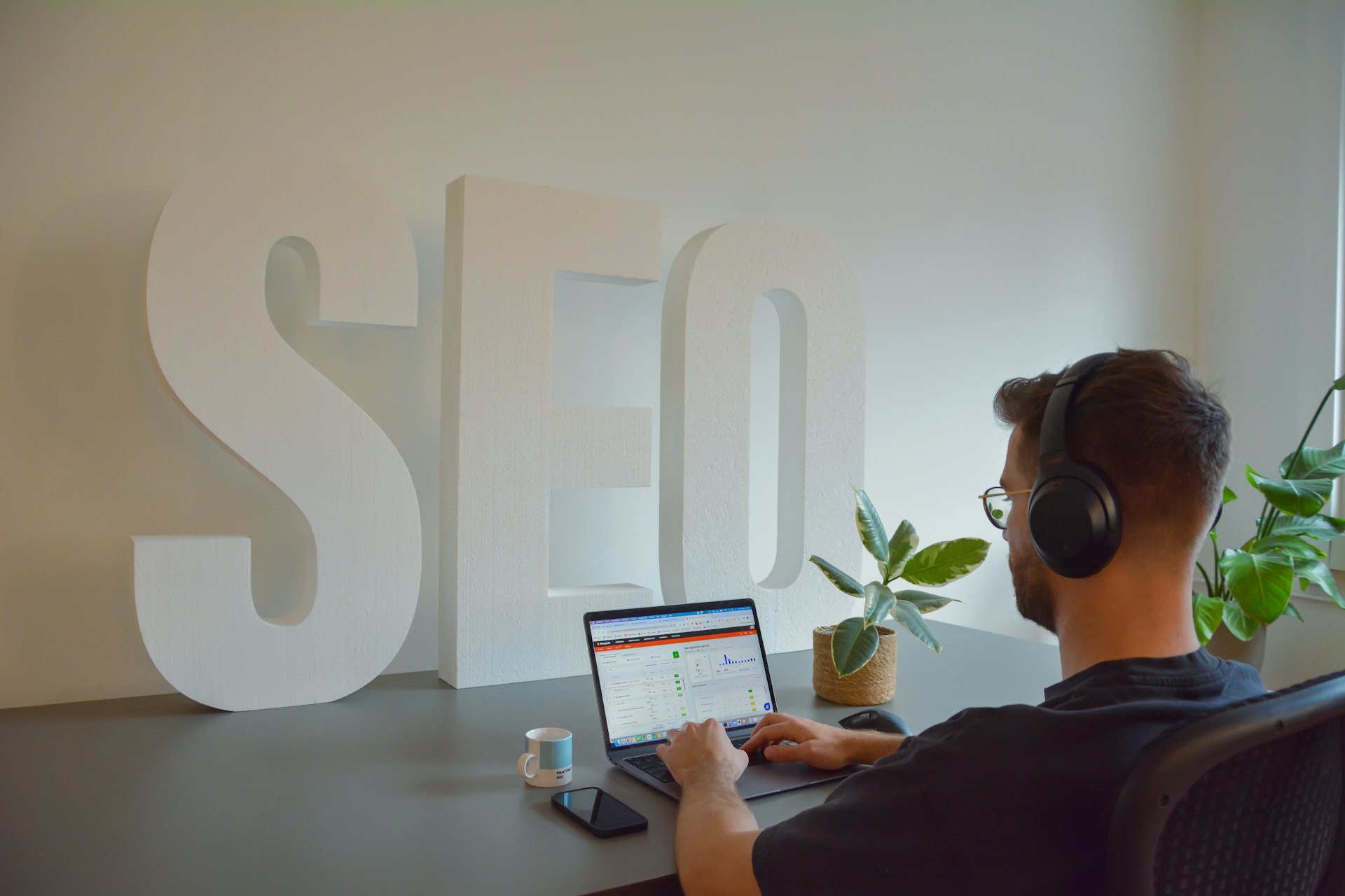 a man sitting in front of a laptop computer and watching SEO Strategies & Trends (2025): A Guide