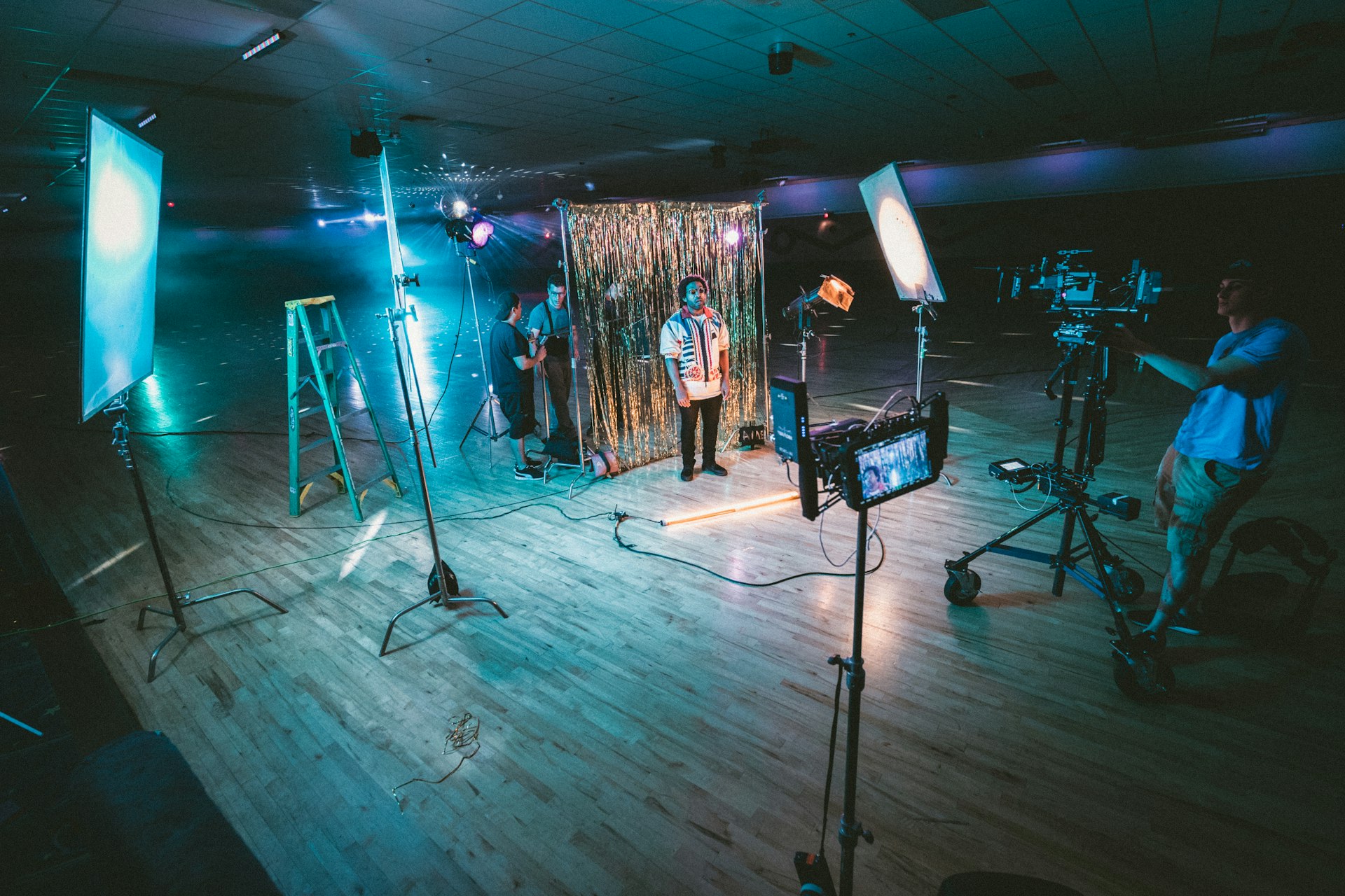 man standing in front of cameras with string lights background and showing The Rise of Visual and Video Search: